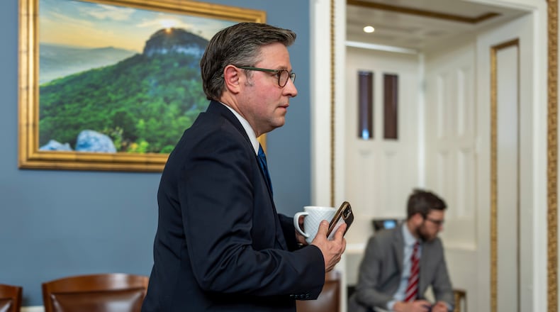 Speaker of the House Mike Johnson, R-La., walks through the House Rules Committee hearing room to meet with Republicans on the panel as they try to advance a federal funding package and prevent a prolonged partial government shutdown, at the Capitol in Washington, Monday, Feb. 2, 2026. (AP Photo/J. Scott Applewhite)