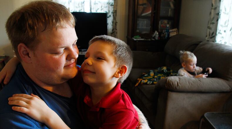 Chris Ullmer, 30, of Harrison Twp., says he doesn't regret dropping out of high school during his junior year but said he and his wife Jennifer are going to do all that they can to make sure their three boys don't follow in his academic footsteps. "I'm more involved than my parents were," Ullmer said. "I make sure they are involved in their classes. We make sure that if they are doing something wrong, we help them out." Ullmer is shown at home with his oldest son Nathan II and youngest son Jackson, 3. PHOTO BY LISA POWELL