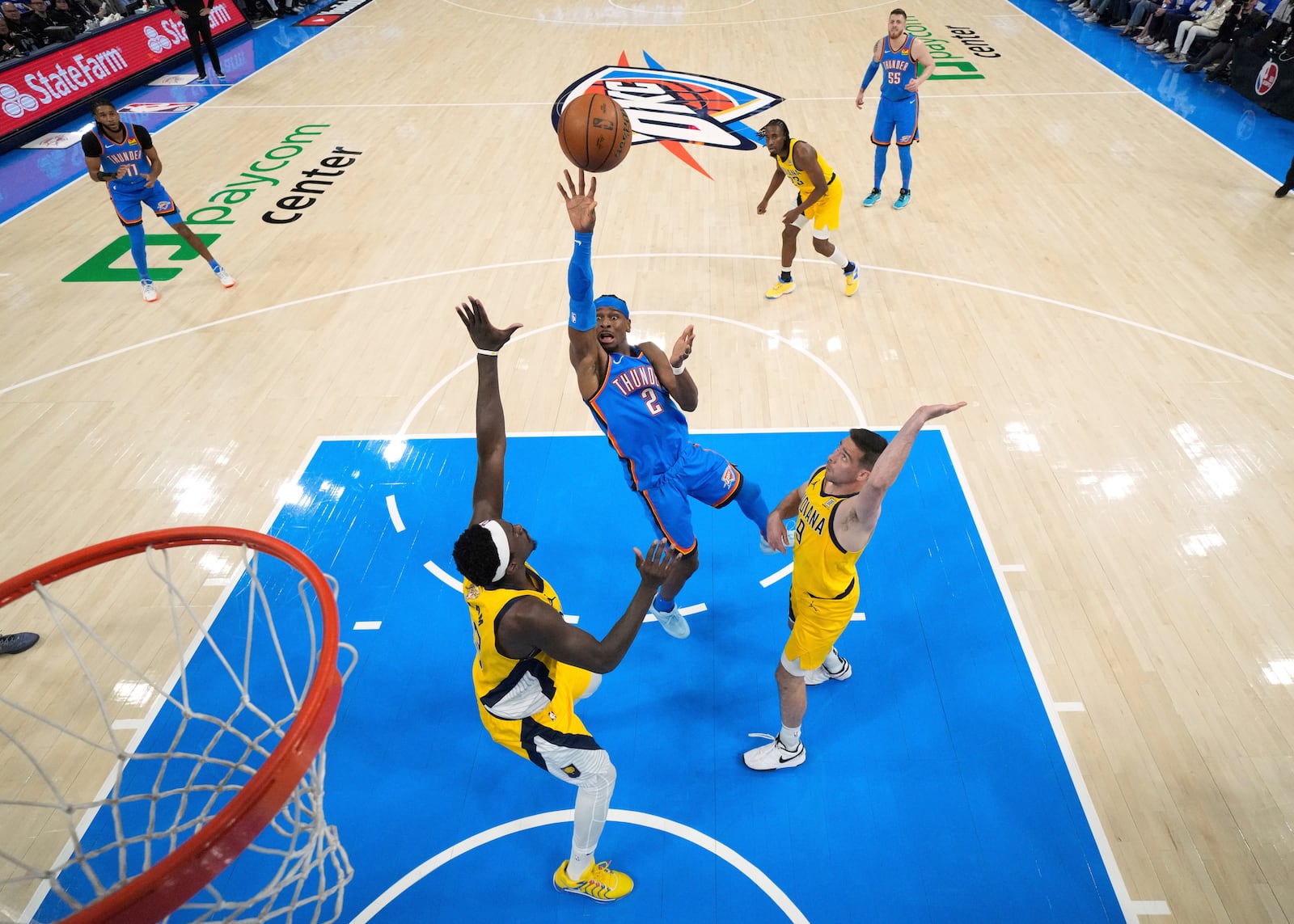 Oklahoma City Thunder guard Shai Gilgeous-Alexander (2) shoots against Indiana Pacers forward Pascal Siakam (43) and guard T.J. McConnell (9) during the first half of Game 2 of the NBA Finals basketball series Sunday, June 8, 2025, in Oklahoma City. (Matthew Stockman/Pool Photo via AP)