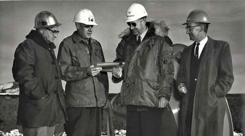 In a Nov. 1961 ceremony at Malmstrom Air Force Base, then-Colonel Harry Goldsworthy, accepts a symbol of the first completed Minuteman operational silo from Army Area Engineer Colonel Arthur H. Lahlum. U.S. Air Force photo