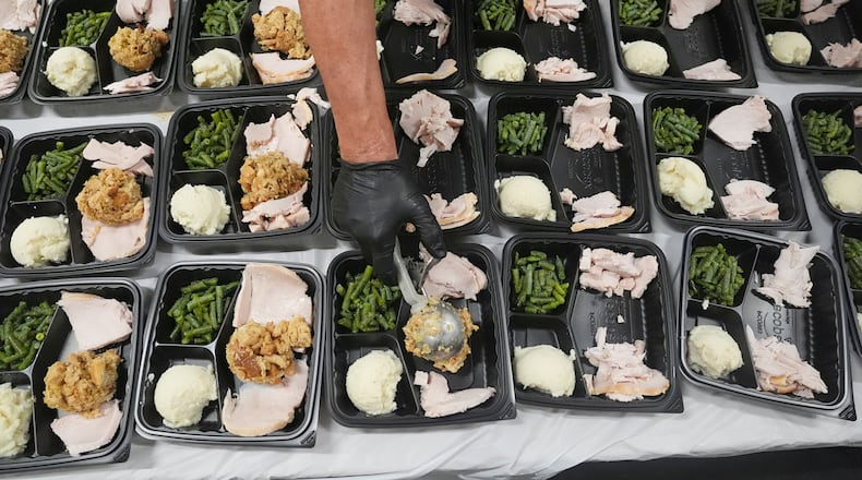 A volunteer prepares meals at the Philabundance Community Kitchen in Philadelphia, Thursday, Oct. 30, 2025. (AP Photo/Matt Rourke)
