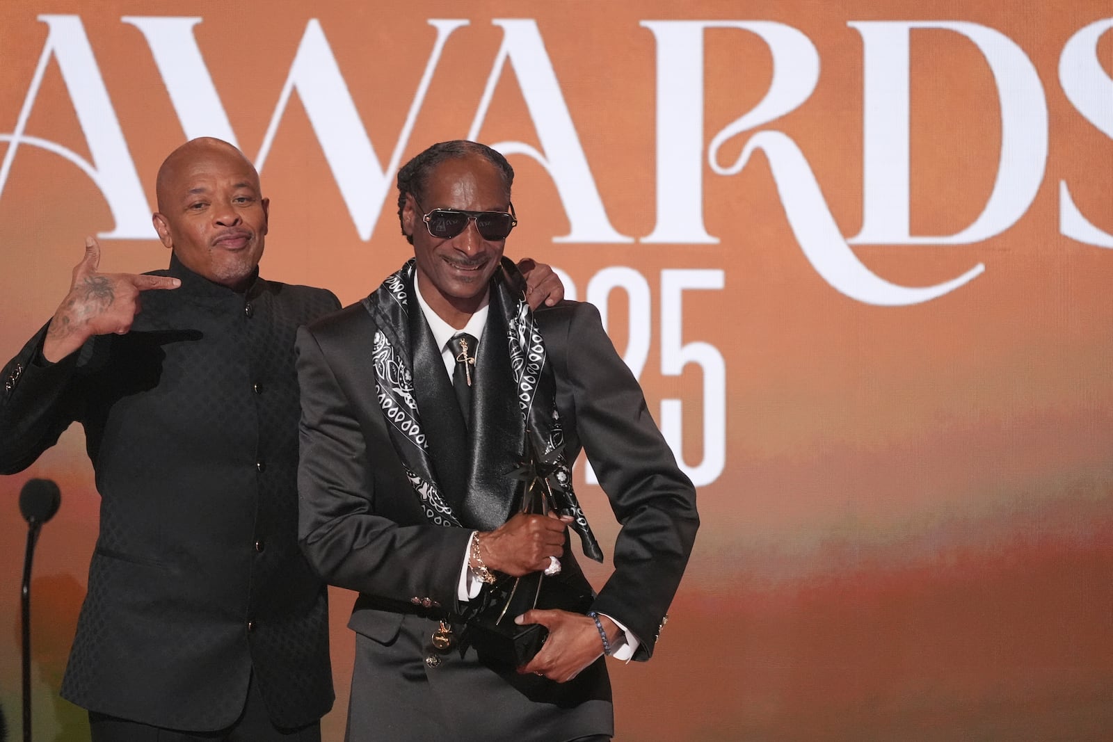 Snoop Dogg, right, accepts the ultimate icon award during the BET Awards on Monday, June 9, 2025, at the Peacock Theater in Los Angeles. Dr. Dre look on from left,(AP Photo/Chris Pizzello)