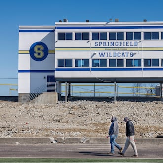 Andew Newcomb, left, and Kale Holbrook, installers with MegaLift, walk past bleachers that are being reconstructed on the track field at Springfield High School on Thursday, Feb. 26, 2026, in Springfield. Renovations of the track, scoreboard and bleachers are scheduled to be done by the end of summer. JOSEPH COOKE / STAFF