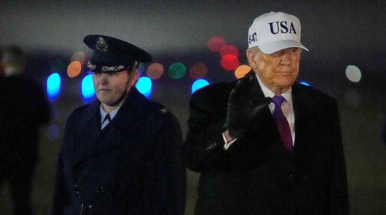 President Donald Trump waves after stepping off Air Force One, Thursday, Feb. 19, 2026, at Joint Base Andrews, Md., on return from a trip to Georgia. (AP Photo/Mark Schiefelbein)