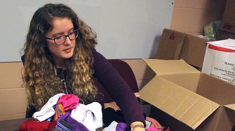 Kenton Ridge High School senior, Emily High sorts through socks that were donated for this year’s Sock Challenge. JEFF GUERINI/STAFF