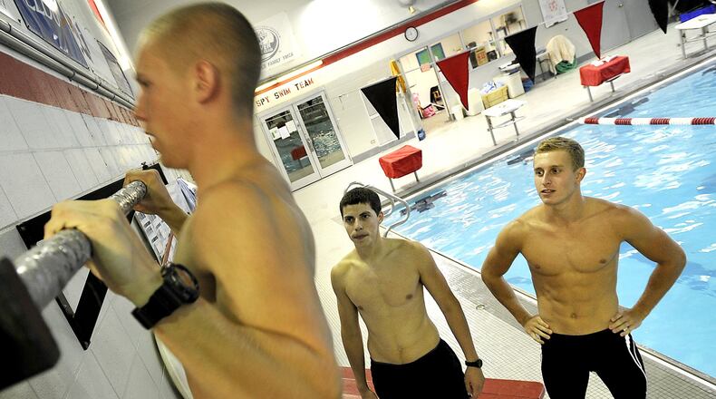 Josh Rotroff, center, and Seth Payton encourage their friend, Andy Lawson, to knock out more pull-ups on a bar at the Springfield YMCA before they start swimming laps. The three Springfield friends have worked out together at the YMCA and will soon leave one after another for Air Force special operations training. Bill Lackey/Staff