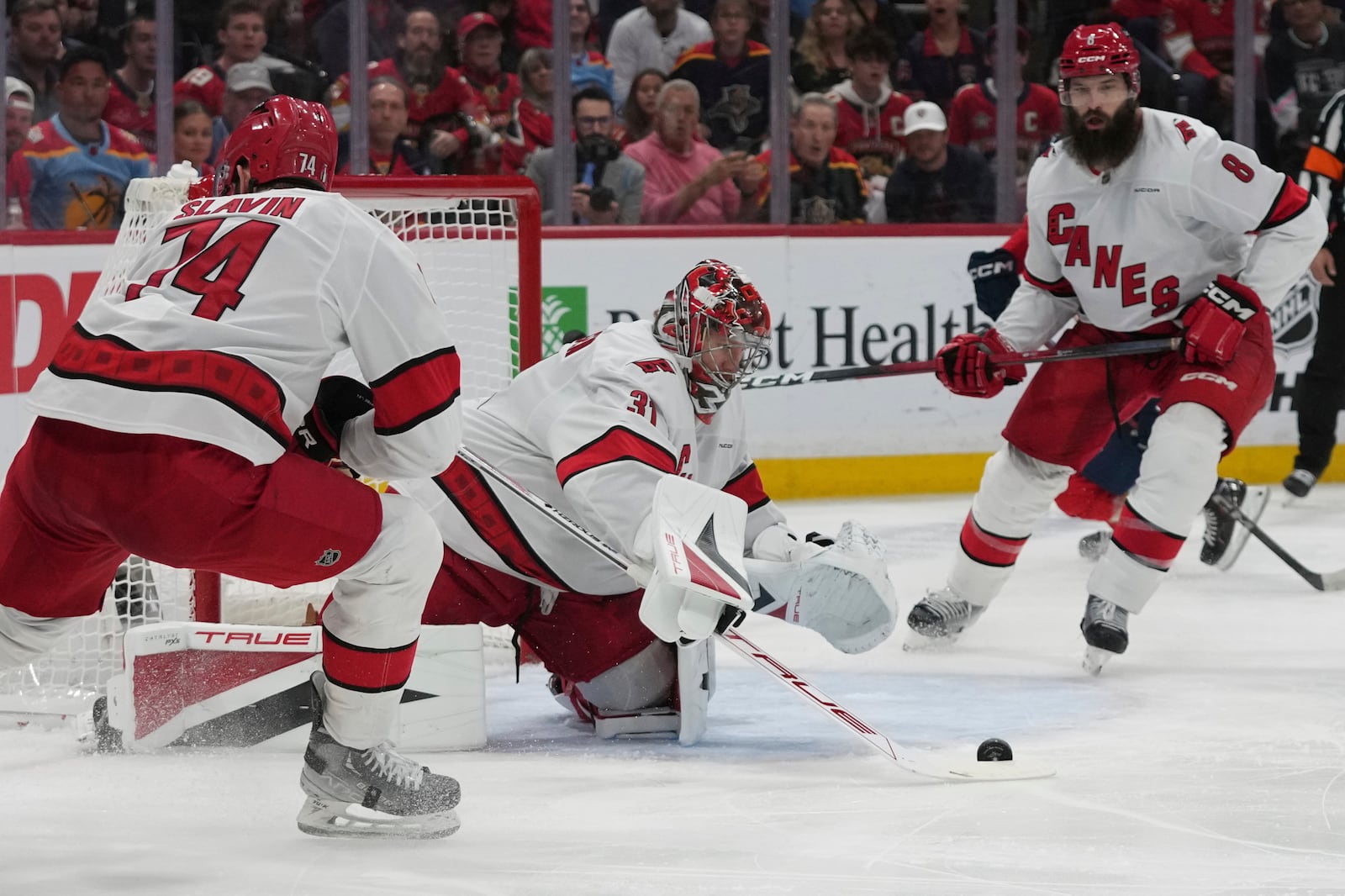 Carolina Hurricanes goaltender Frederik Andersen (31) deflects a shot on goal during the second period in Game 4 of the NHL hockey Stanley Cup Eastern Conference finals against the Florida Panthers, Monday, May 26, 2025, in Sunrise, Fla. (AP Photo/Lynne Sladky)