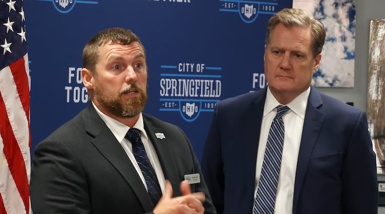 Springfield City Manager Bryan Heck speaks following a meeting with Congressman Mike Turner, in background, about the thousands of Haitian immigrants who have located in Springfield. BILL LACKEY/STAFF