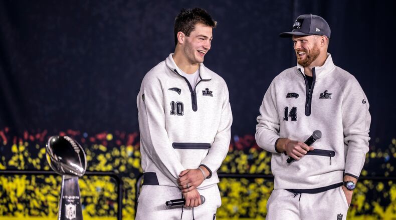 New Englad Patriots quarterback Drake Maye, left, and Seattle Seahawks quarterback Sam Darnold, right, smile on stage with the Lombardi Trophy during the NFL Super Bowl Opening Night, Monday, Feb. 2, 2026, in San Jose, Calif., ahead of the Super Bowl 60 football game between the New England Patriots and the Seattle Seahawks. (Carlos Avila Gonzalez/San Francisco Chronicle via AP)
