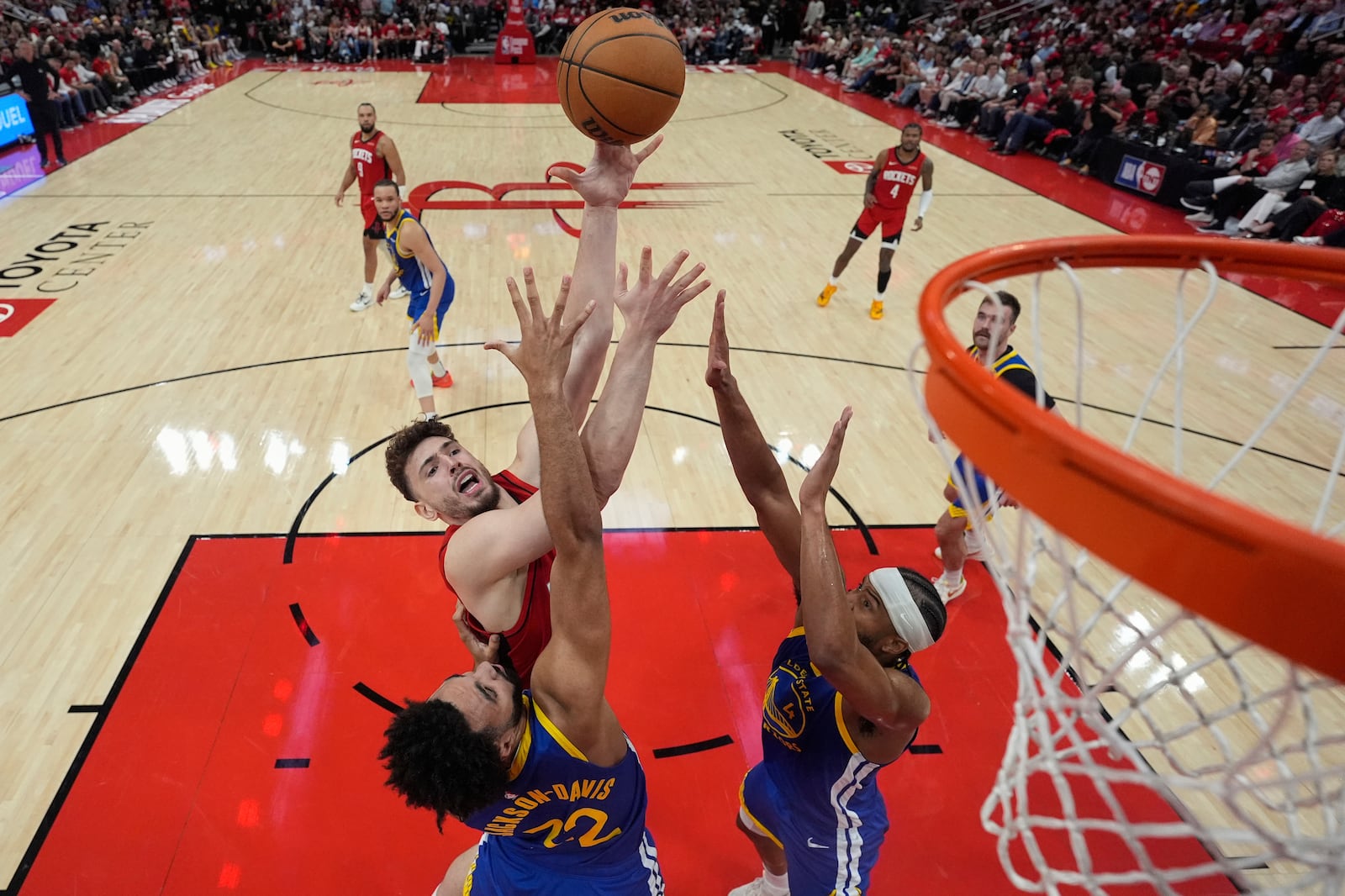 Houston Rockets center Alperen Sengun shoots over Golden State Warriors forward Trayce Jackson-Davis (32) and guard Moses Moody (4) during the second half of Game 5 of an NBA basketball first-round playoff series, Wednesday, April 30, 2025, in Houston. (AP Photo/David J. Phillip)