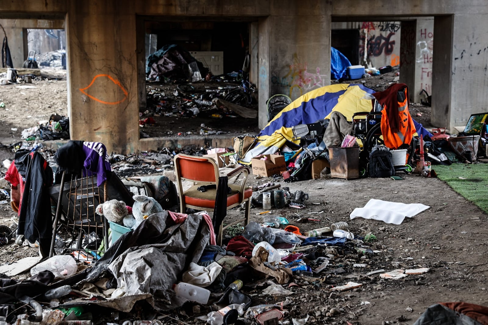 A homeless encampment that was on East Monument Ave. under a railroad trestle in 2023. JIM NOELKER/STAFF