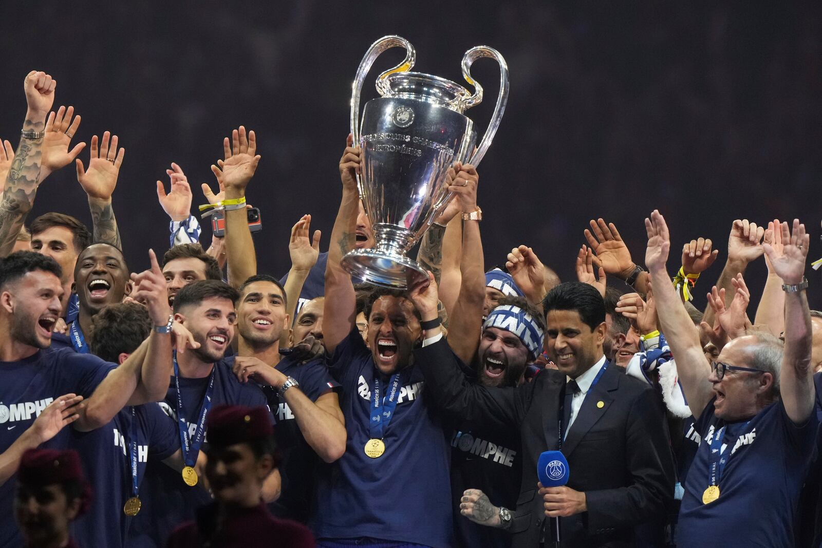 PSG's team captain Marquinhos holds the trophy during a celebration at the Parc des Princes stadium after the team won the Champions League final soccer match between Paris Saint-Germain and Inter Milan Sunday, June 1, 2025 in Paris. (AP Photo/Michel Euler)