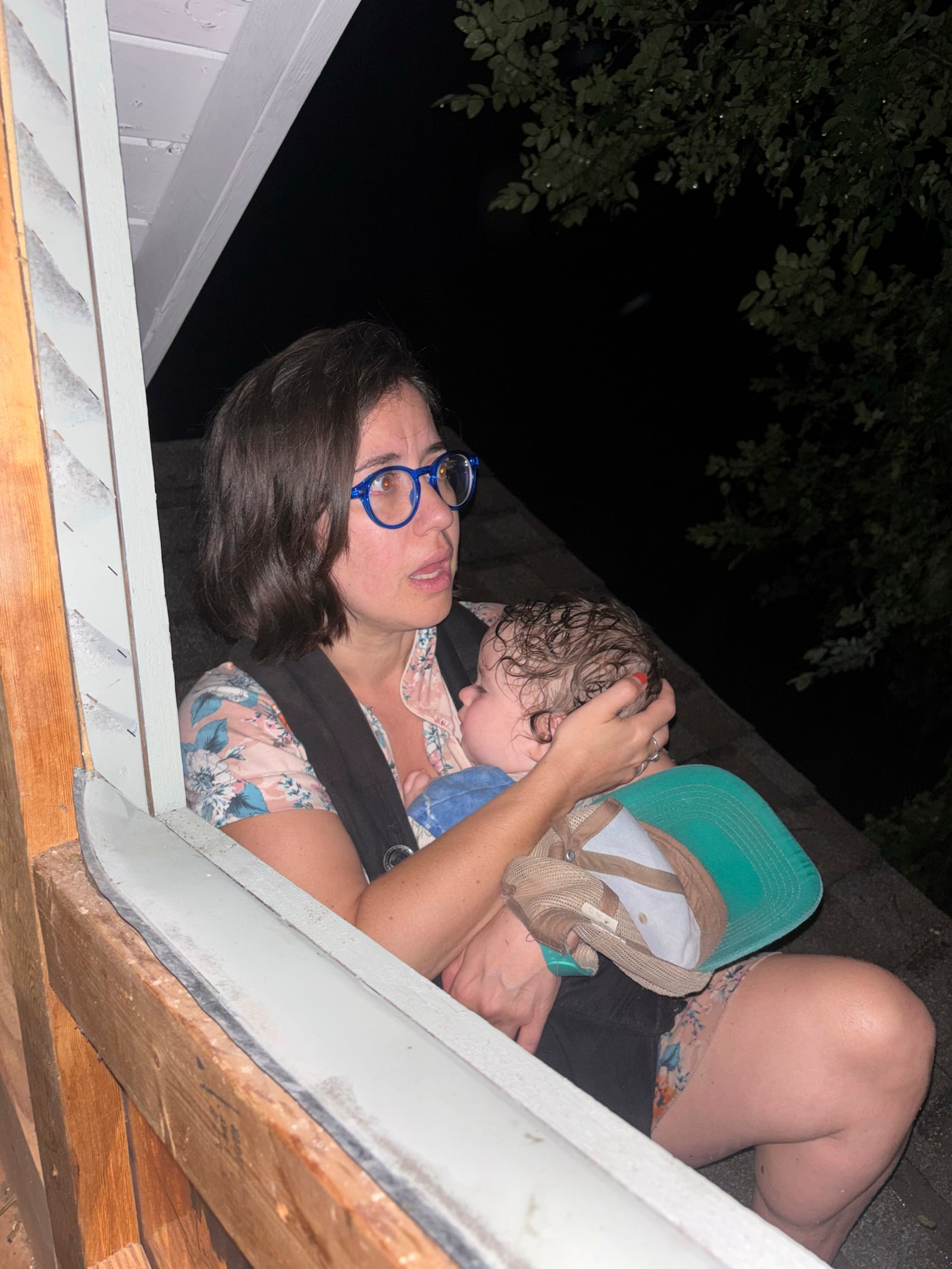 Shabd Simon-Alexander holds her one-year-old daughter on the roof of a cabin to escape floodwaters from the Guadalupe River in Hunt, Texas, at 5:27 a.m. on Friday, July 4, 2025. (Jane Towler via AP)