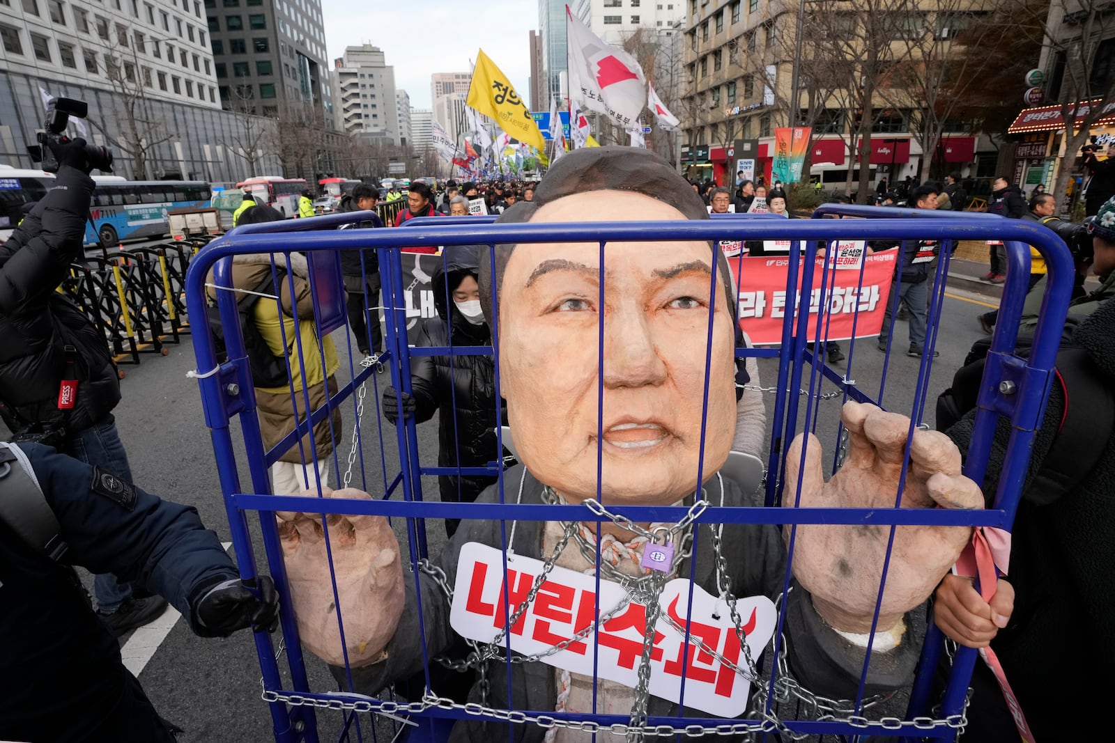 FILE - Protesters carry a caricature of South Korean President Yoon Suk Yeol after a rally demanding his impeachment in Seoul, South Korea, on Dec. 12, 2024. (AP Photo/Ahn Young-joon, File)