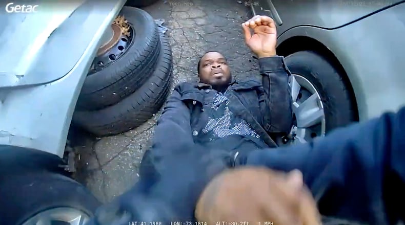 In this photo taken from video released by the Bridgeport Police Department, Dyshan Best looks up at Bridgeport Police officer Yoon Heo after being shot by Heo during a chase, Monday, March 31, 2025, in Bridgeport, Conn. (Bridgeport Police Department via AP)