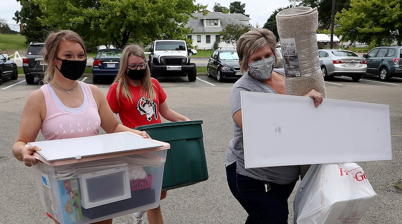 Wittenberg freshman Chloe Jordan, left, gets a hand moving into Tower Hall from her sister, Abbey, and mother, Melanie, Wednesday. BILL LACKEY/STAFF