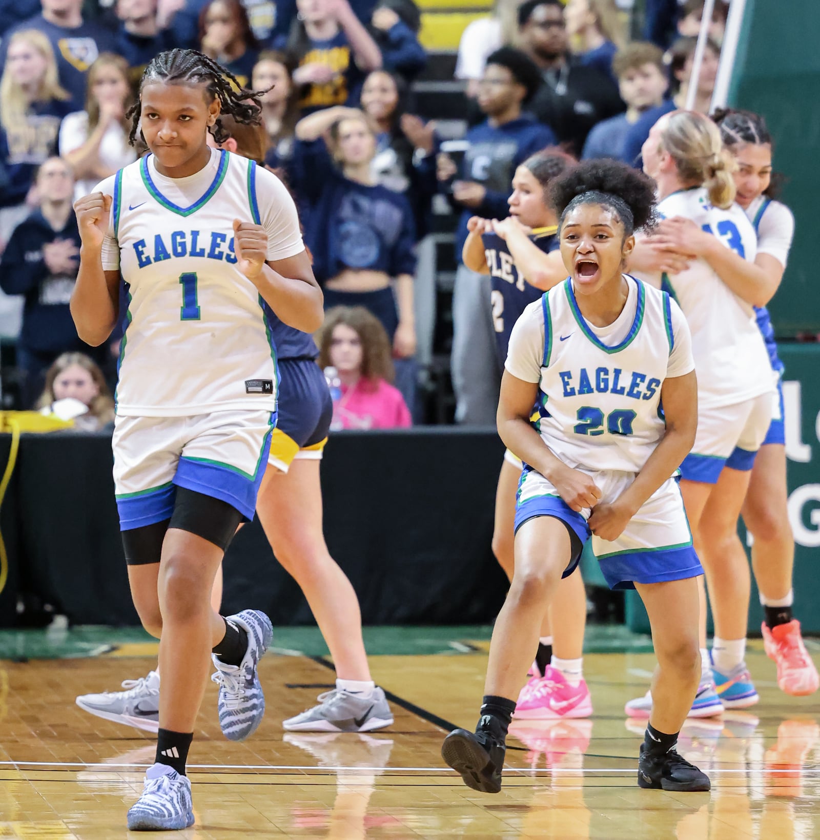 Chaminade-Julienne freshman guard Ja'Kyiah Cook (left) and senior guard Janae Cain (right) celebrate after defeating Copley 62-57 in a Division III state semifinal on Thursday, March 12 at Ervin J. Nutter Center in Fairborn. BRYANT BILLING / STAFF