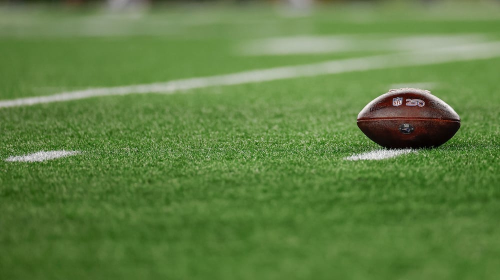 FILE - A football with the NFL shield logo rests on the turf during the second half of an NFL wild card playoff football game between the New England Patriots and the Los Angeles Chargers, Jan. 11, 2026, in Foxborough, Mass. (AP Photo/Greg M. Cooper, File)