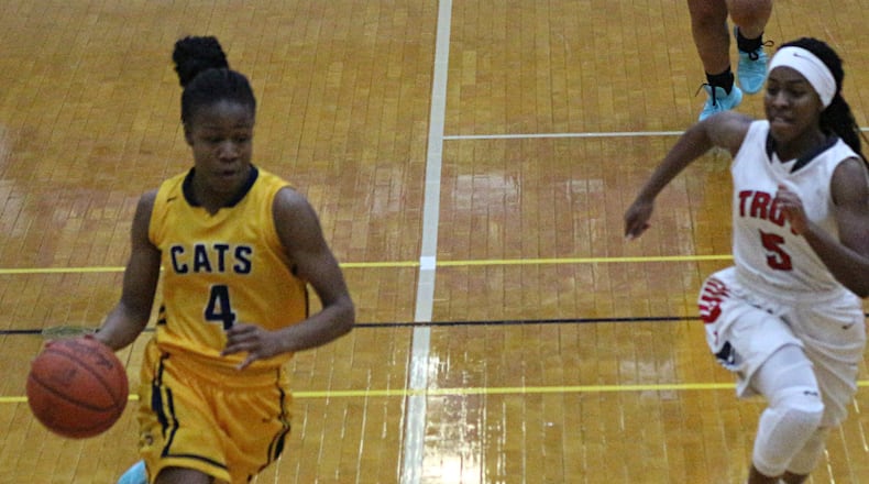 Springfield senior Caralyssa Byrd (left) scored 14 points to help the Wildcats win their first tournament game since North and South merged for the 2009 season. GREG BILLING / CONTRIBUTED