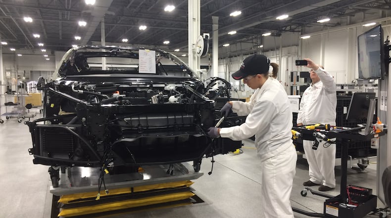 A worker at the Performance Manufacturing Center in Marysville, Ohio assembles the 2017 Acura NSX. KATHERINE COLLINS/STAFF
