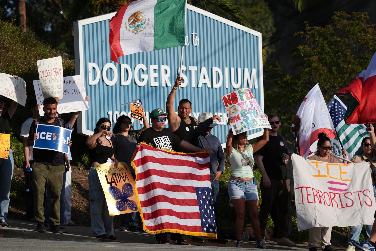 FILE - Demonstrators stage outside Dodger Stadium, June 21, 2025, in Los Angeles. (AP Photo/Damian Dovarganes, file)
