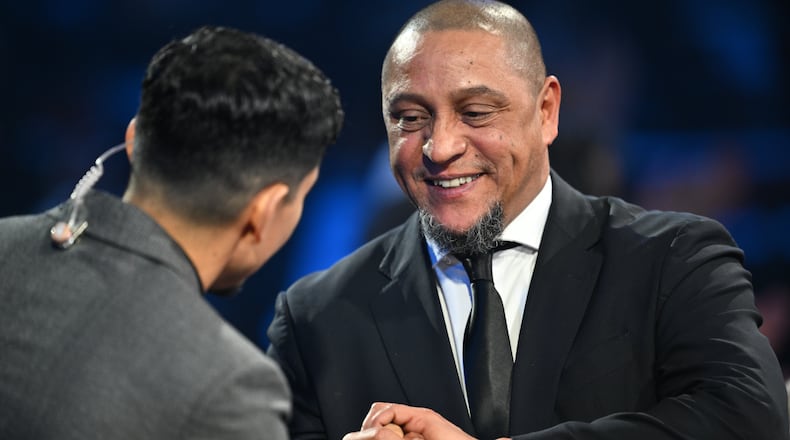 Former Brazil star Roberto Carlos is interviewed by actor Danny Ramirez during the draw for the 2026 soccer World Cup at the Kennedy Center in Washington, Friday, Dec. 5, 2025. (Mandel Ngan/Pool Photo via AP)