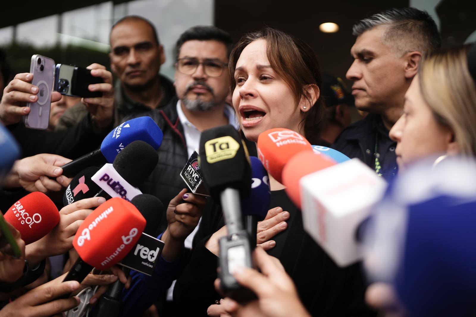 Maria Claudia Tarazona, the wife of Colombian Senator Miguel Uribe Turbay who was shot at a political rally, talks to the press outside the clinic where he is being treated, in Bogota, Colombia, Sunday, June 8, 2025. (AP Photo/Ivan Valencia)