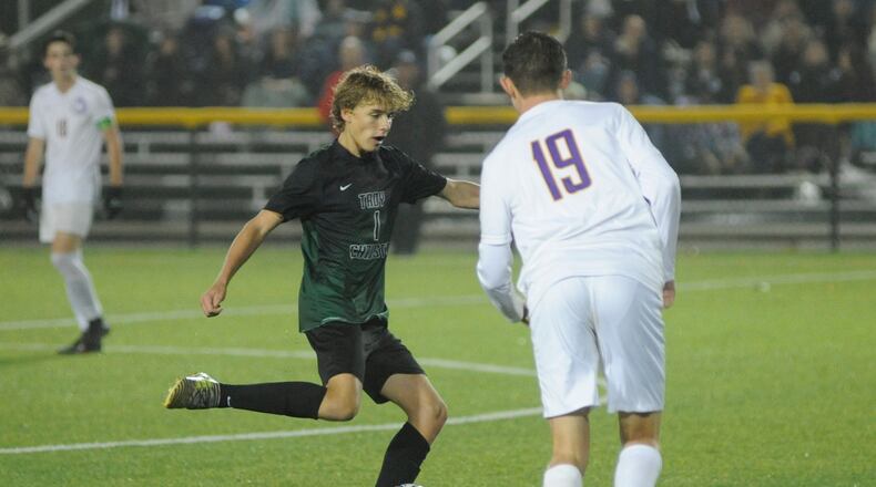 Chas Schemmel of Troy Christian (left) controls the ball. MARC PENDLETON / STAFF