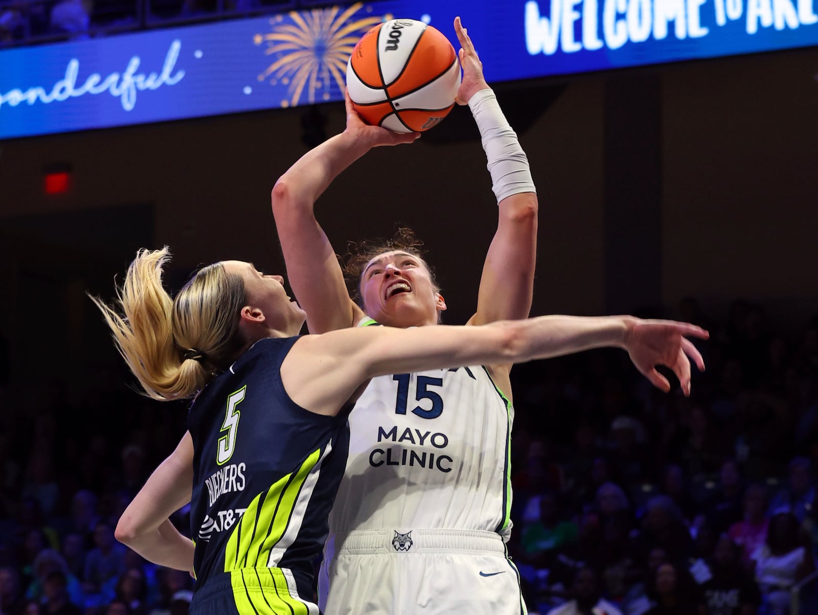Dallas Wings guard Paige Bueckers (5) fouls Minnesota Lynx forward Jessica Shepard (15) who shoots in the second half of a WNBA basketball game Friday, May 16, 2025, in Arlington, Texas. (AP Photo/Richard W. Rodriguez)