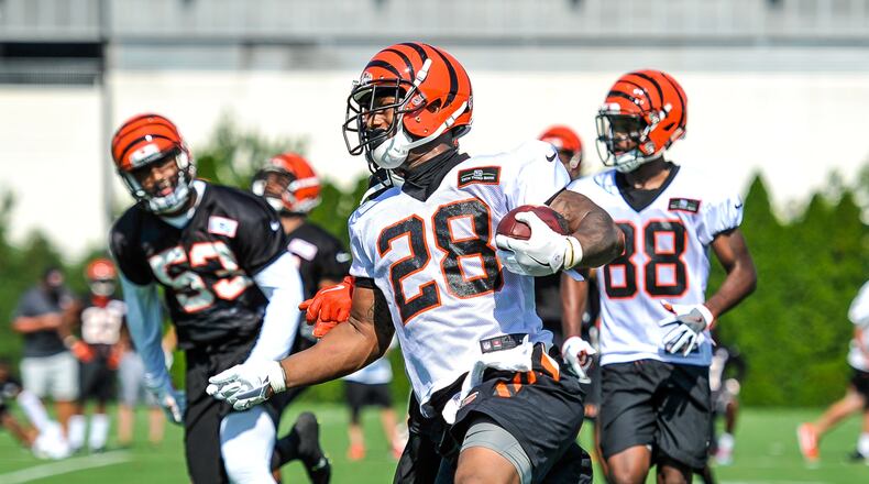 Running back Joe Mixon carries the ball during the first day of Cincinnati Bengals Training Camp Friday, July 28 at the practice fields beside Paul Brown Stadium in Cincinnati. NICK GRAHAM/STAFF