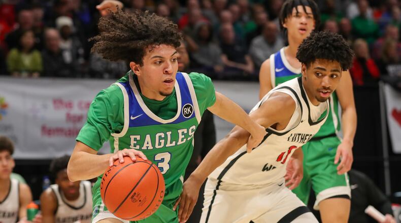 Chaminade Julienne High School senior George Washington III drives past Lutheran West's Lewis Smith during a Division II state semifinal game on Friday morning at University of Dayton Arena. CONTRIBUTED BY MICHAEL COOPER
