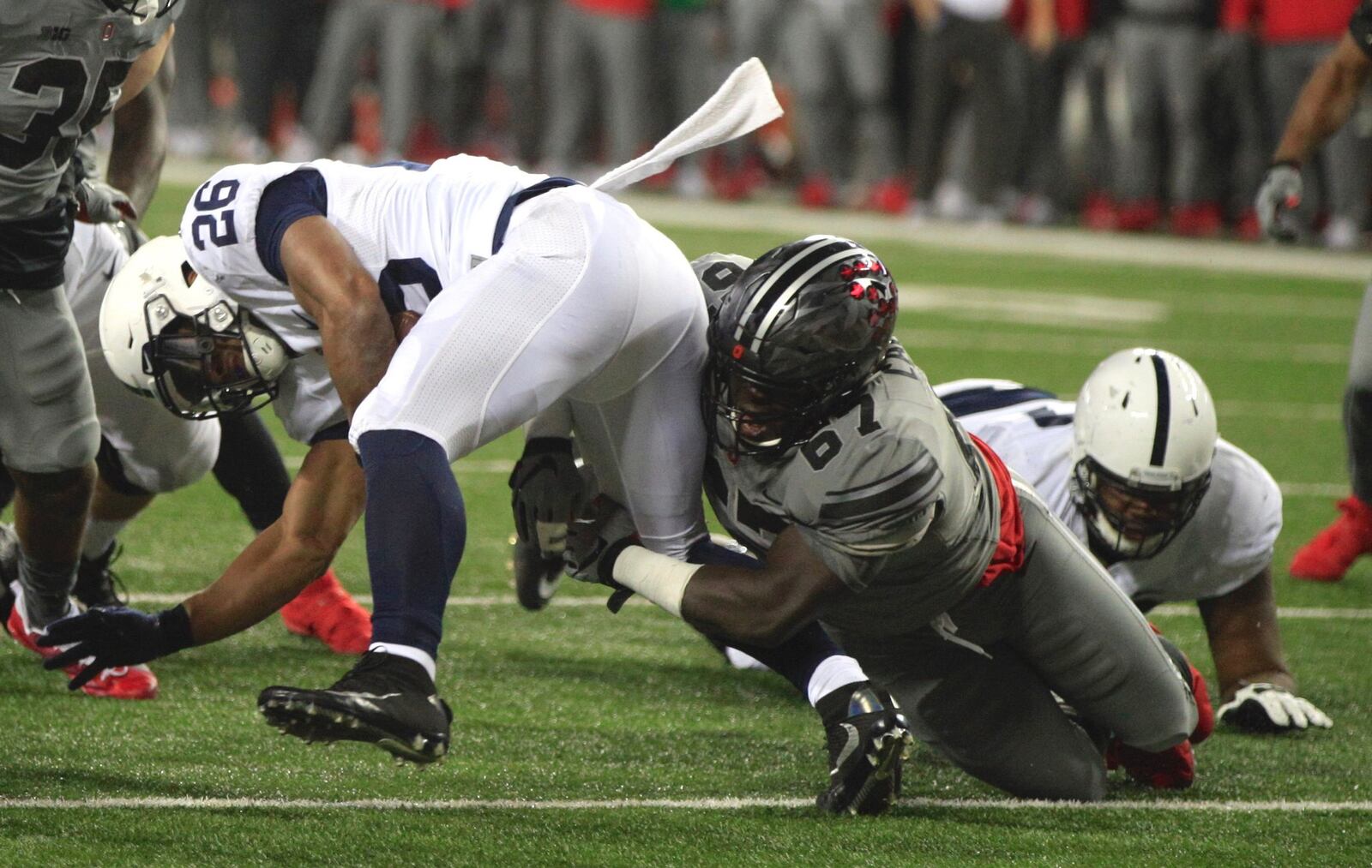 Ohio State’s Robert Landers tackles Penn State’s Saquon Barkely for a loss in the fourth quarter on Saturday, Oct. 28, 2017, at Ohio Stadium in Columbus. David Jablonski/Staff