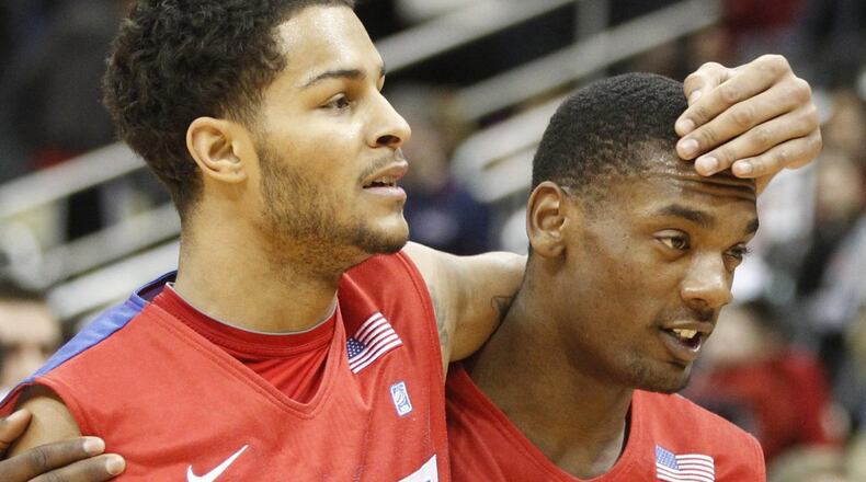 Dayton’s Devin Oliver and Dyshawne Pierre leave the court after a victory against Duquesne on Saturday, Feb. 22, 2014, at the CONSOL Energy Center in Pittsburgh, Pa. David Jablonski/Staff