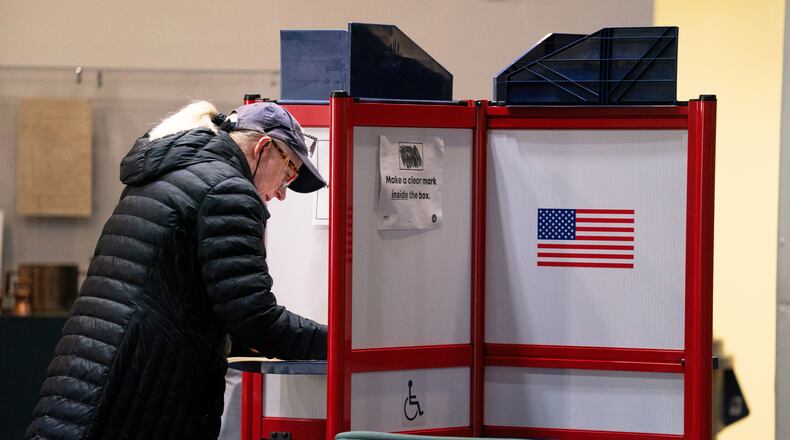 A voter completes her ballot at Alexandria City Hall, Tuesday, Nov. 4, 2025, in Alexandria, Va. (AP Photo/Allison Robbert)