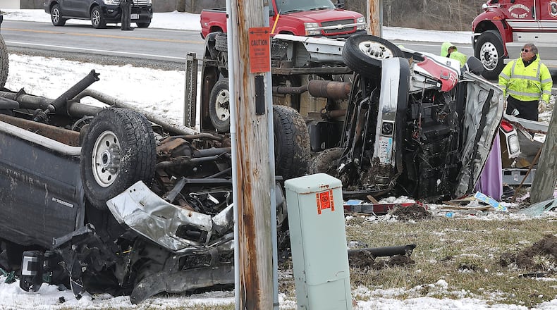 Emergency personnel look over the scene of a crash at the intersection of Ohio 36 and Parkview Road in Champaign County on Wednesday, March 21, 2018. One person was killed and four were taken to area hospitals by medical helicopter. Bill Lackey/Staff