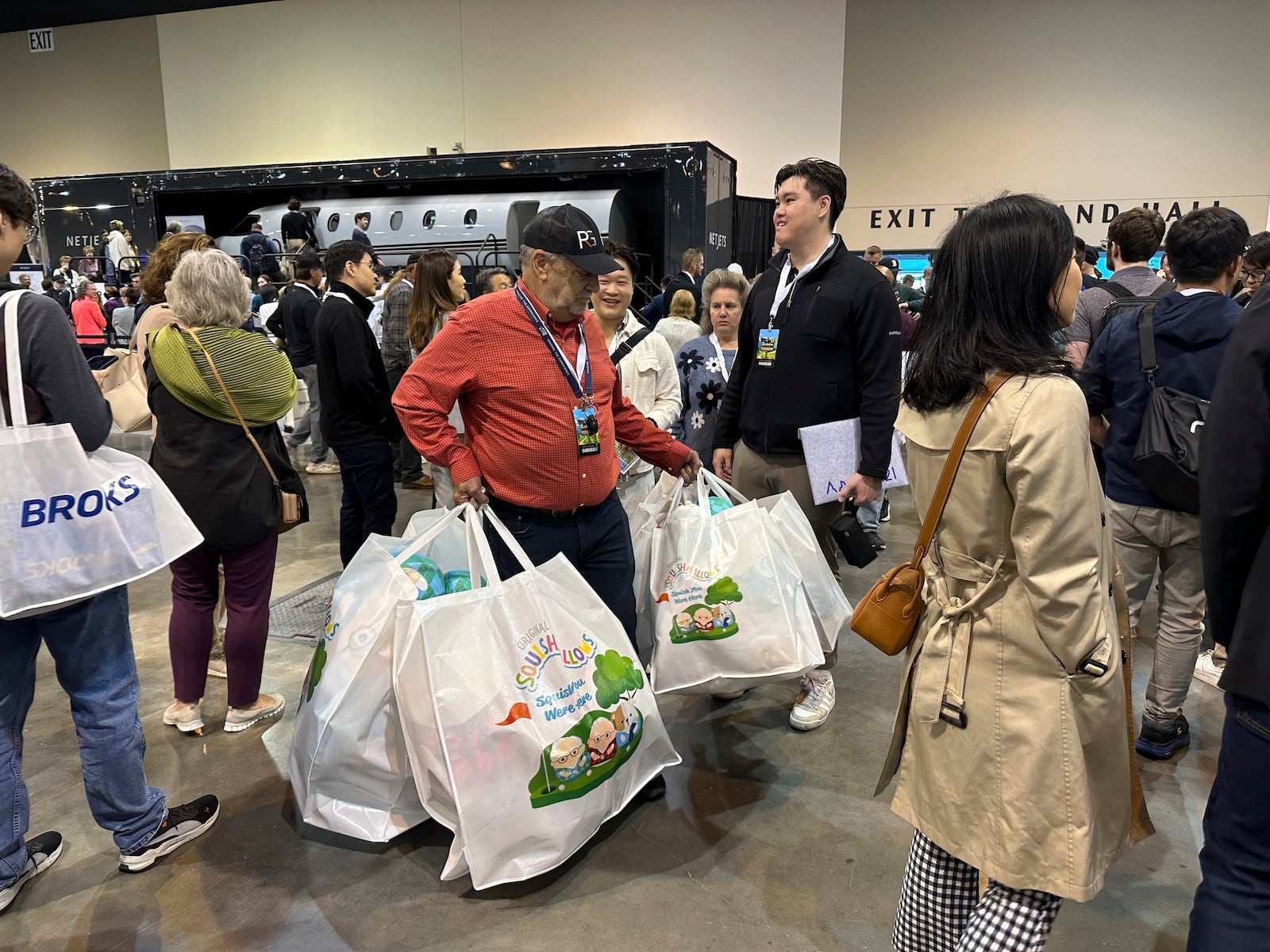 Berkshire Hathaway shareholder Devan Bisher holds five large bags filled with Warren Buffett and Charlie Munger Squishmallows while waiting in line on Friday, May 2, 2025 in Omaha, Neb. (AP Photo/Josh Funk)