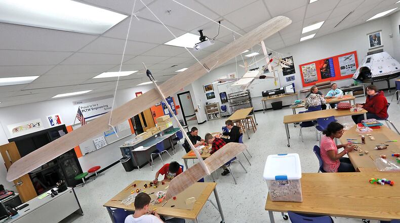 Balsa wood airplanes designed by a class at Graham Middle School twirl in the wind as the hang from the ceiling of the classroom Wednesday, May 2, 2018. Bill Lackey/Staff