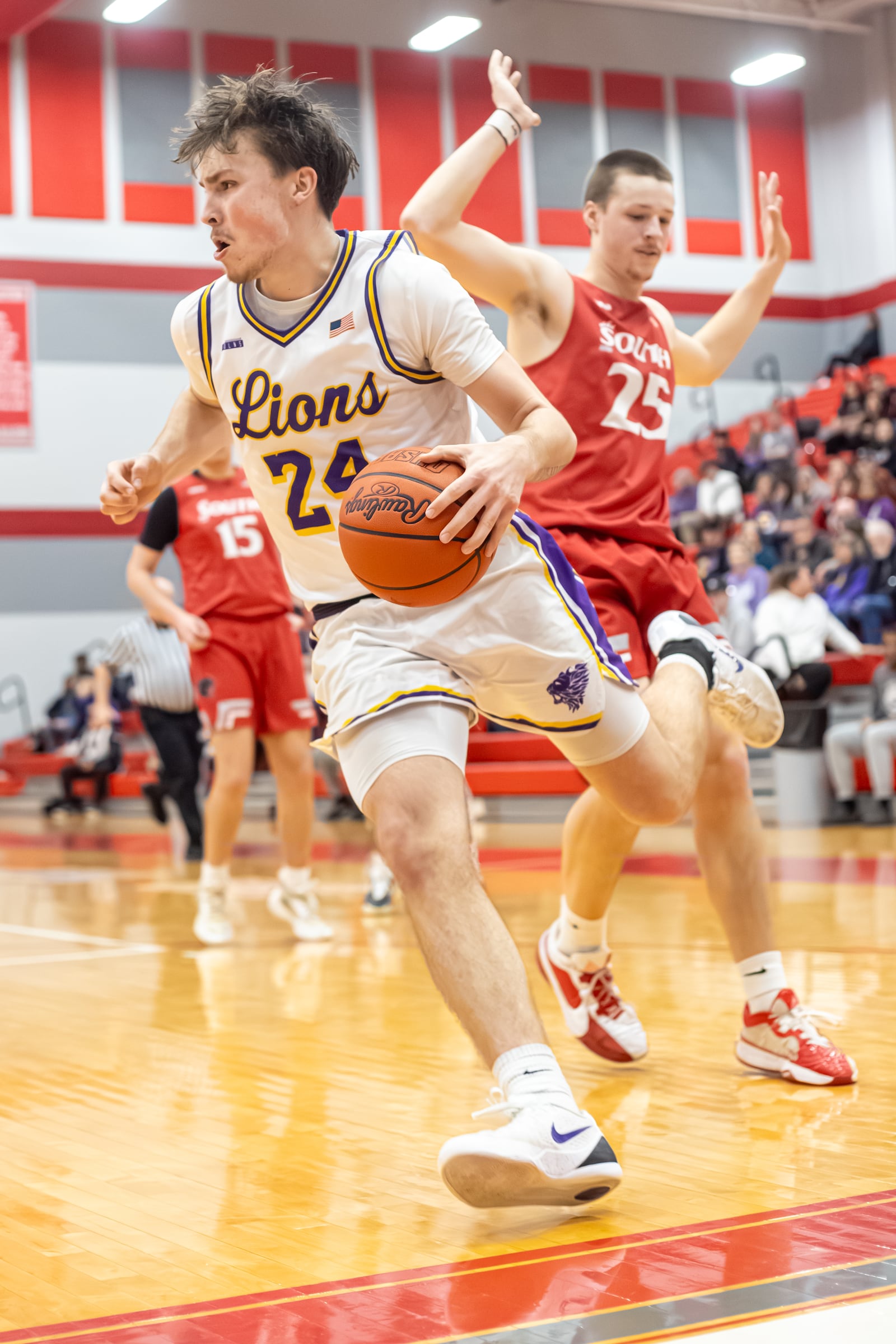 Emmanuel Christian senior Nate Hudson drives past Twin Valley South junior Trent Ray during their Division VI district semifinal game on Monday, March 3, 2026 at Troy High School. The Lions won 73-51. MICHAEL COOPER / STAFF