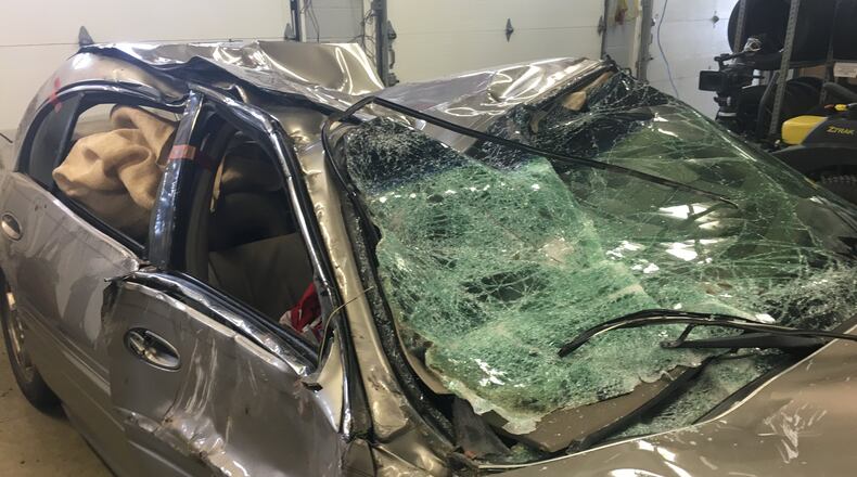 This Buick Century crashed into a house on East Southern Avenue and Delta Road early Wednesday. The suspect fled on foot and Ohio State Highway Patrol is actively looking for him.