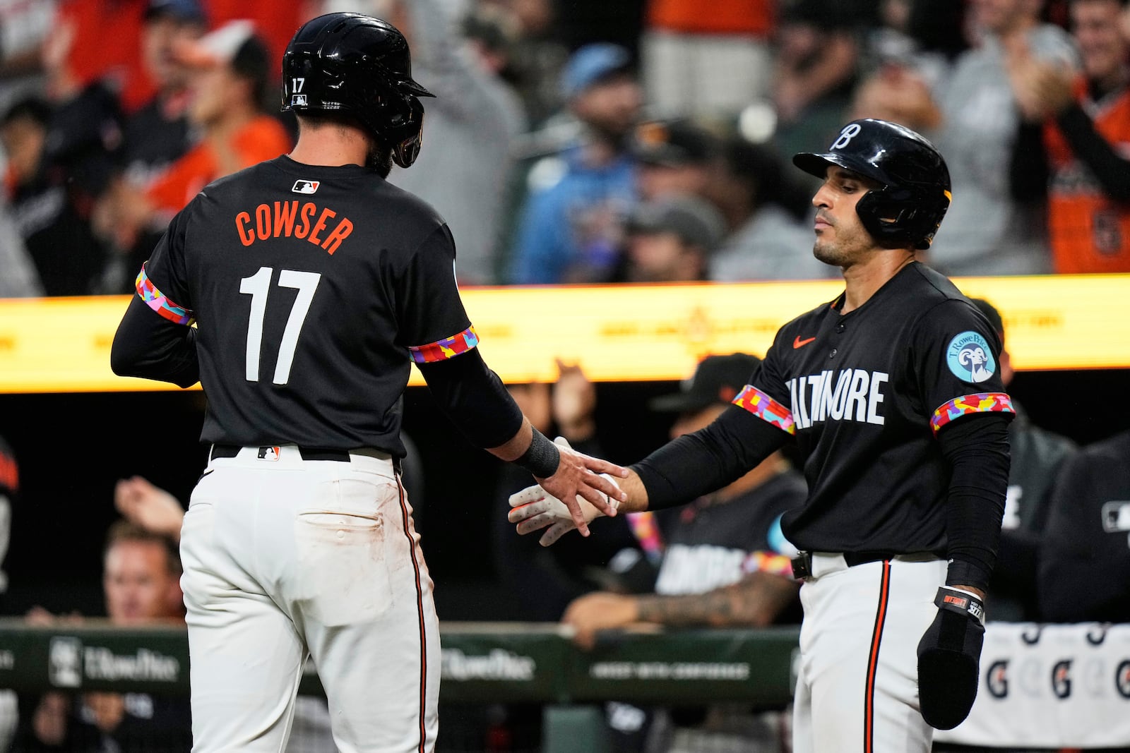 Baltimore Orioles' Colton Cowser (17) and Ramon Laureano, right, celebrate after scoring on a two-run RBI hit by Coby Mayo during the second inning of a baseball game, Friday, June 27, 2025, in Baltimore. (AP Photo/Stephanie Scarbrough)