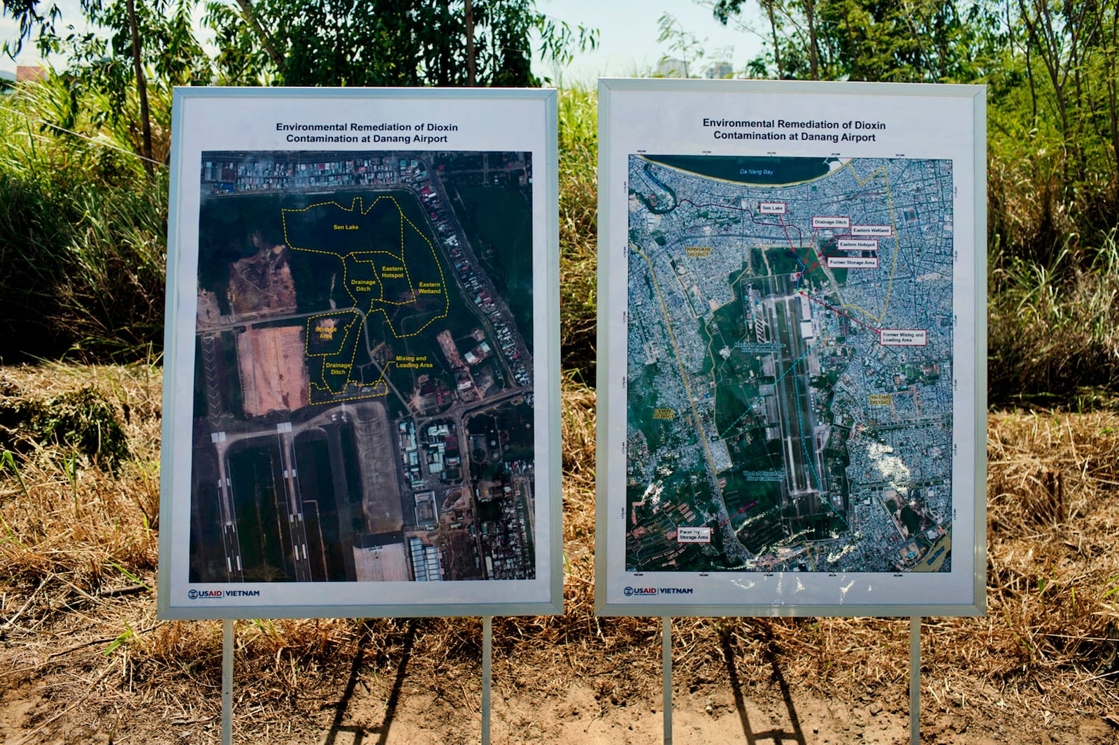FILE- Maps of the area contaminated with dioxin around Danang airport are displayed during a ceremony marking the start of a project to clean up dioxin left over from the Vietnam War, at a former U.S. military base in Danang, Vietnam Thursday Aug. 9, 2012. (AP Photo/Maika Elan, File)