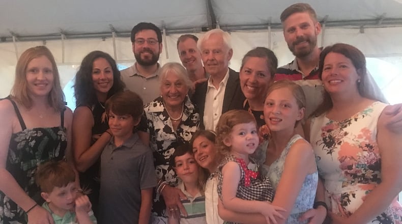 Helen and Tom Martin stand at the center of their family during their 50th anniversary party.