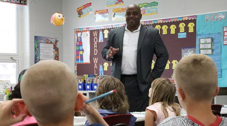 Walter Sledge, the new principal at Snyder Park Elementary, answers questions about himself from students Wednesday on the first day of school. BILL LACKEY/STAFF