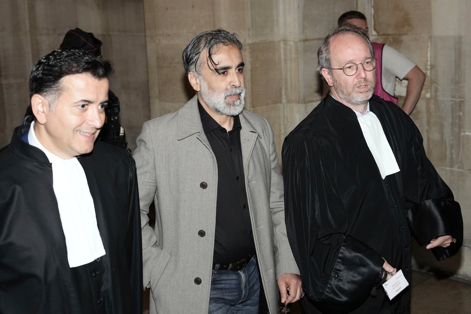 Abderrahmane Ouatiki, center, who was working as a hotel receptionist, is flanked by his lawyers Mohand Ouidja, left, and Henri De Beauregard during the trial of the 2016 armed robbery of Kim Kardashian, at the palace of justice, Tuesday, May 13, 2025 in Paris. (AP Photo/Aurelien Morissard)