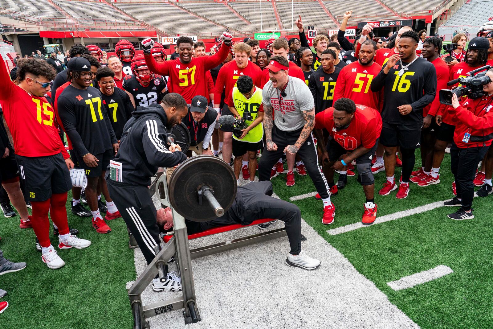 Nebraska special teams coordinator Mike Ekeler bench presses during an NCAA college football practice Saturday, April 26, 2025, in Lincoln, Neb. (AP Photo/Dylan Widger)