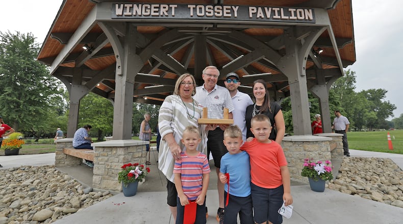 The Wingert Family poses for a picture in front of the Wingert Tossey Pavilion which they funded at the Snyder Park Gardens Saturday during the Jubilee. BILL LACKEY/STAFF