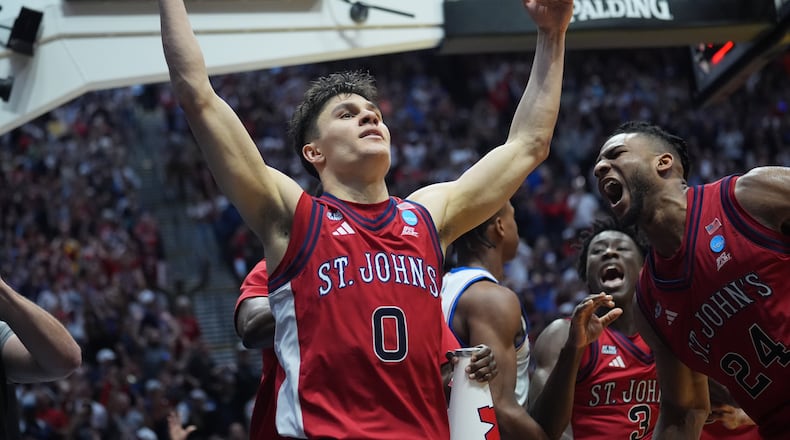 St. John's guard Dylan Darling (0) celebrates after St. John's defeated Kansas in the second round of the NCAA college basketball tournament Sunday, March 22, 2026, in San Diego. (AP Photo/Marcio Jose Sanchez)