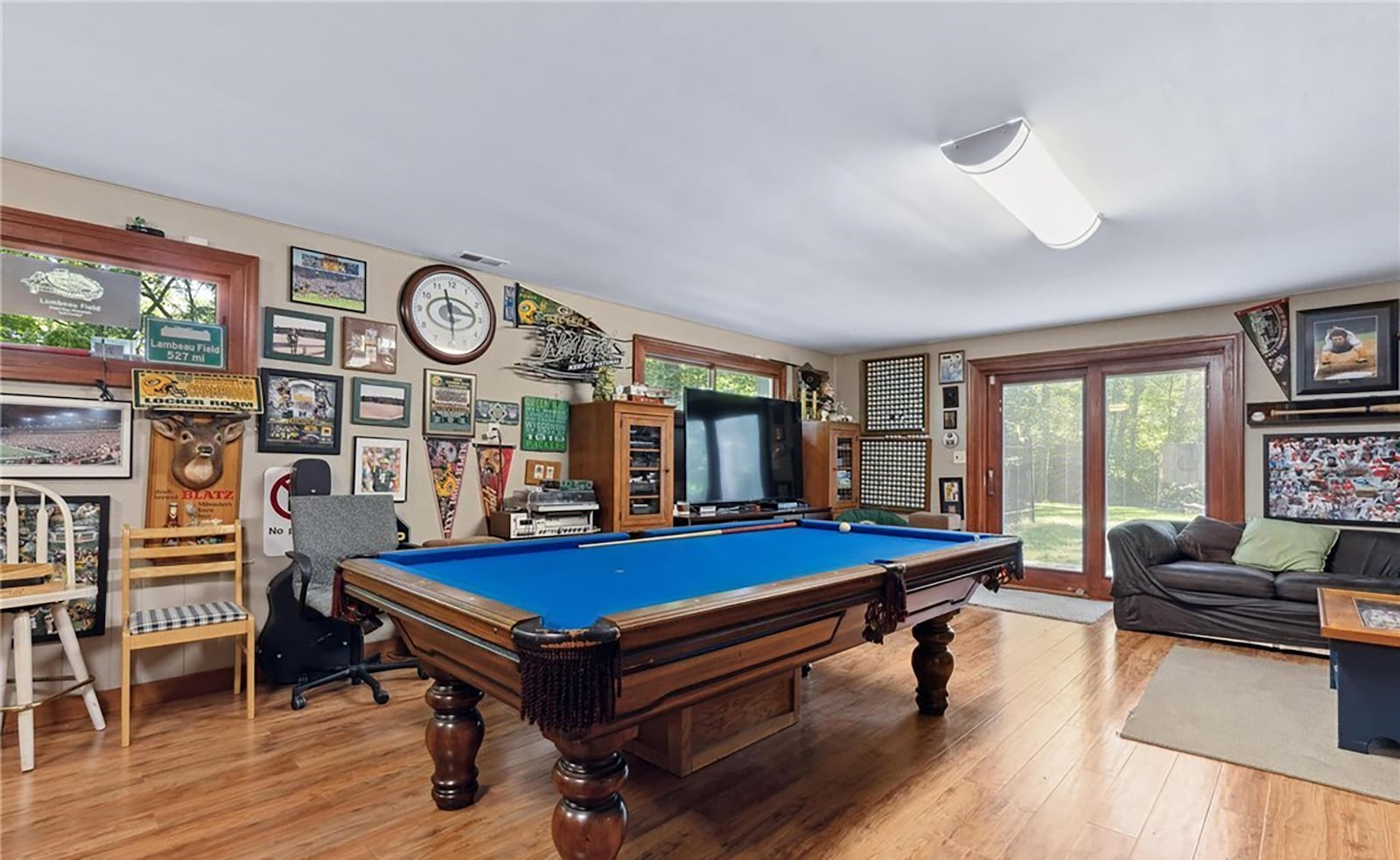 The basement level is finished with a recreation room with wood flooring, French exterior doors and ceiling lights. CONTRIBUTED
