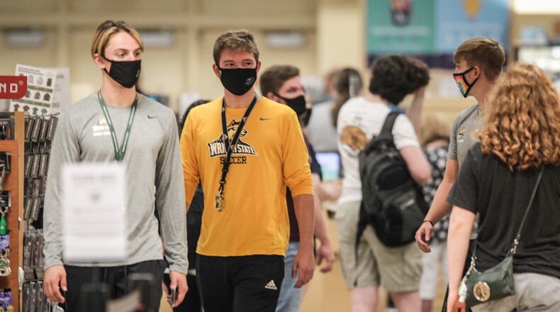 Wright State University student, in limited numbers, returned to class Monday August 24, 2020. There were students lined up in the bookstore practicing social distancing and almost all students were wearing masks. JIM NOELKER/Staff