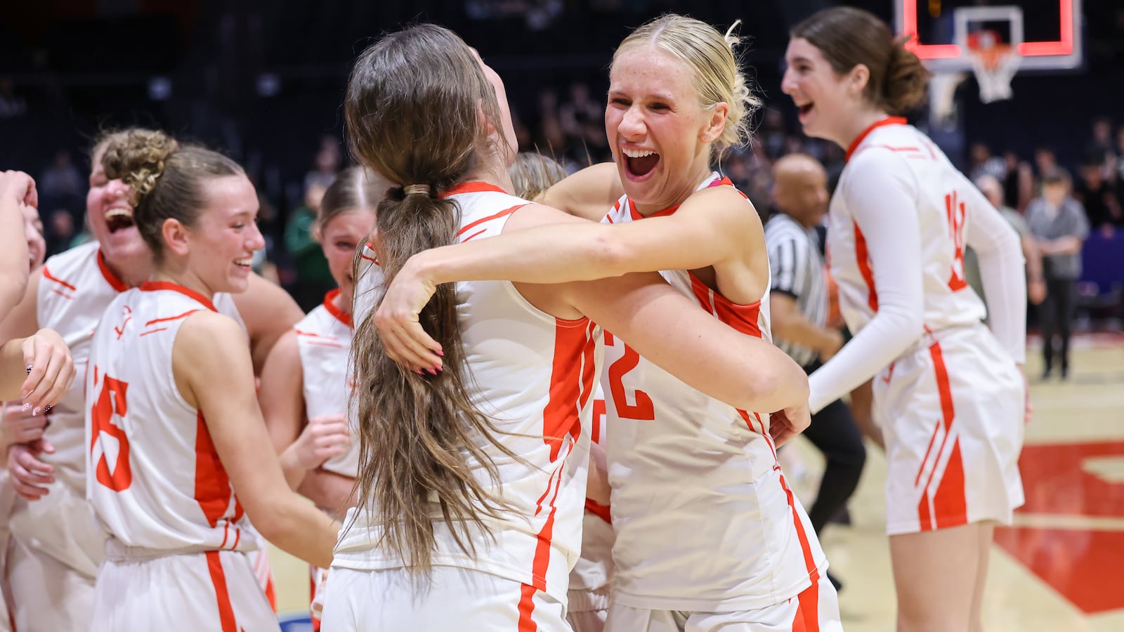 St. Henry senior guard Alexis Buschur hugs senior forward Molly Wendel shortly after the buzzer sounds in the Division VI state championship on Friday, March 13 at University of Dayton Arena. The Redskins beat Canton Central Catholic 53-34 to win the program's first state title. Wendel didn't play after suffering an injury in a semifinal win on Thursday. BRYANT BILLING / STAFF
